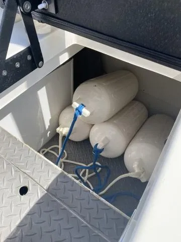 Slide: The Image of Storage compartment with boat fenders on a 2016 Sea Ray 280 SLX. - 10
