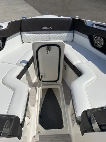 Slide: The Image of 2016 Sea Ray 280 SLX boat interior with white seating and storage compartment. - 11