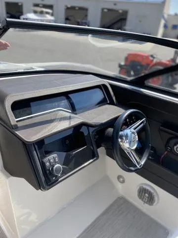 Slide: The Image of 2016 Sea Ray 280 SLX boat dashboard with steering wheel and controls. - 12