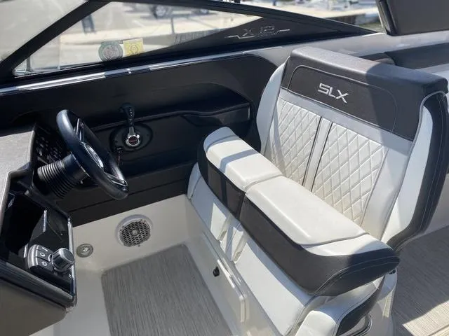 Slide: The Image of Interior of 2016 Sea Ray 280 SLX boat with sleek seating and steering wheel. - 13