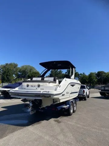 Slide: The Image of 2016 Sea Ray 280 SLX boat on trailer under clear blue sky. - 3