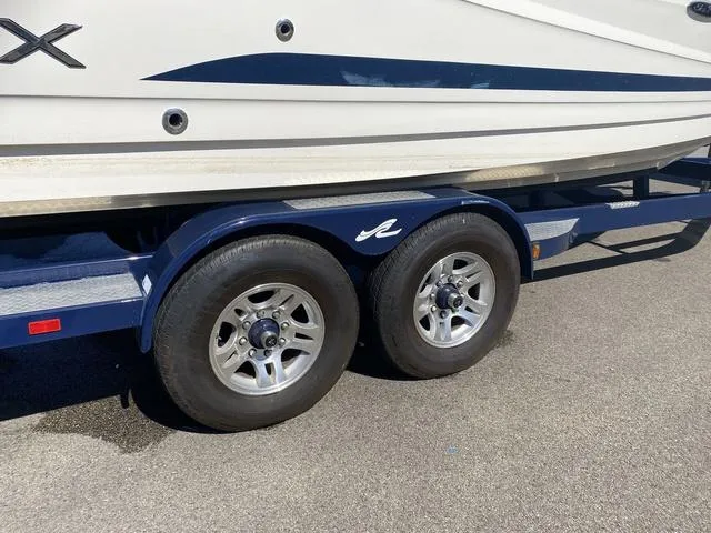 Slide: The Image of 2016 Sea Ray 280 SLX boat on a dual-axle trailer, close-up view. - 4