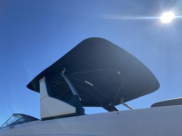 Slide: The Image of 2016 Sea Ray 280 SLX boat with sunshade against clear blue sky. - 6