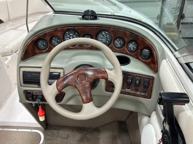 Slide: The Image of Dashboard of a 1997 Chaparral 2130 SS boat with wood accents and steering wheel. - 11