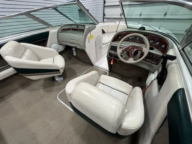 Slide: The Image of Interior of a 1997 Chaparral 2130 SS boat with white seating and dashboard. - 12