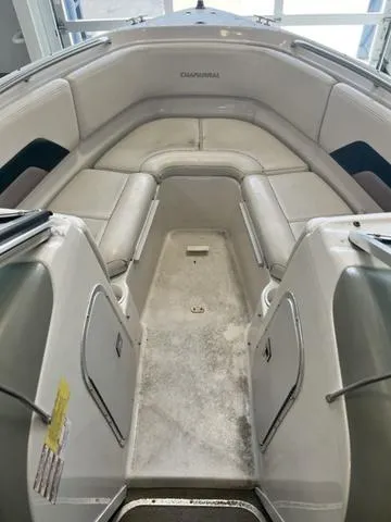 Slide: The Image of 1997 Chaparral 2130 SS boat interior with cushioned seating and storage compartments. - 14