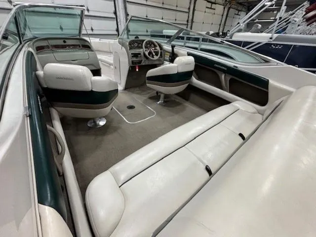 Slide: The Image of 1997 Chaparral 2130 SS boat interior with white and green seating, steering wheel, and dashboard. - 18