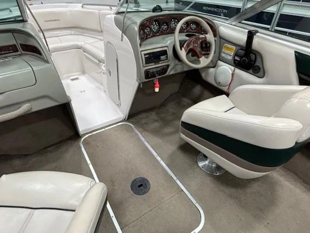 Slide: The Image of Interior of a 1997 Chaparral 2130 SS boat with beige seating and dashboard. - 24