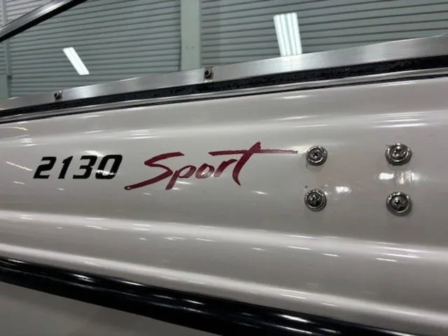 Slide: The Image of 1997 Chaparral 2130 SS boat with "Sport" logo in a showroom. - 6