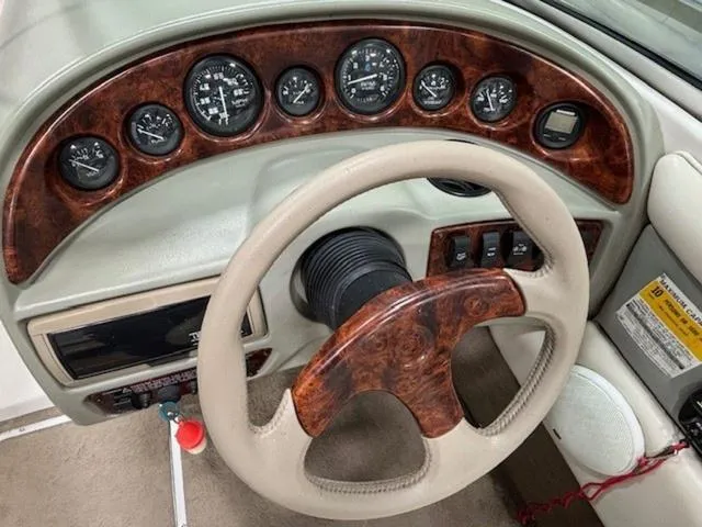 Slide: The Image of Dashboard of a 1997 Chaparral 2130 SS boat with wood accents and gauges. - 7