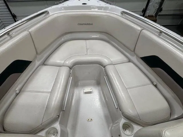 Slide: The Image of 1997 Chaparral 2130 SS boat interior with white cushioned seating. - 8