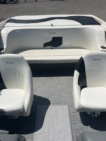 Slide: The Image of 1999 Rinker 212 Bowrider Captiva interior with white seating and gray flooring. - 10