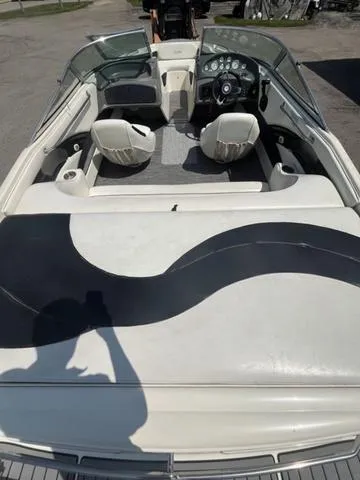 Slide: The Image of 1999 Rinker 212 Bowrider Captiva interior, featuring seating and dashboard. - 11