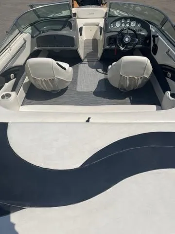 Slide: The Image of 1999 Rinker 212 Bowrider Captiva interior with dual seats and dashboard view. - 12