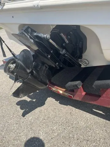 Slide: The Image of 1999 Rinker 212 Bowrider Captiva boat on trailer, showing outboard motor and propeller. - 3