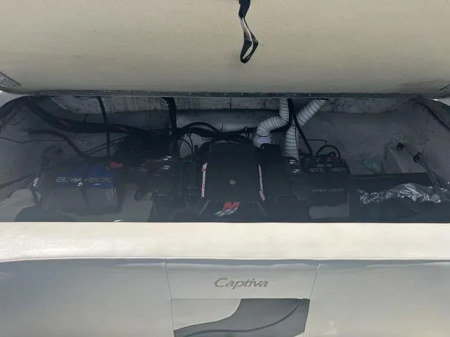 Slide: The Image of 1999 Rinker 212 Bowrider Captiva engine compartment with visible components and wiring. - 5