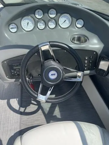 Slide: The Image of 1999 Rinker 212 Bowrider Captiva dashboard with steering wheel and gauges. - 9