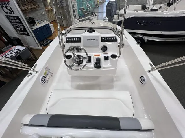 Slide: The Image of 2024 Robalo 206 Cayman boat interior with steering console and seating. - 11