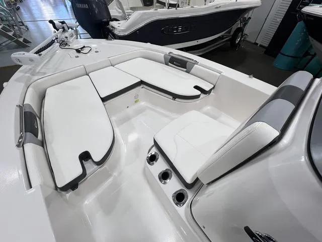Slide: The Image of 2024 Robalo 206 Cayman boat interior with white seating and modern design. - 13
