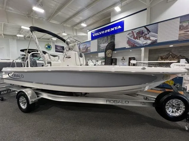 Slide: The Image of 2024 Robalo 206 Cayman boat displayed indoors on a trailer. - 3