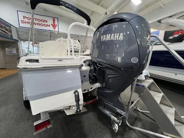 Slide: The Image of 2024 Robalo 206 Cayman boat with Yamaha outboard motor in showroom. - 5