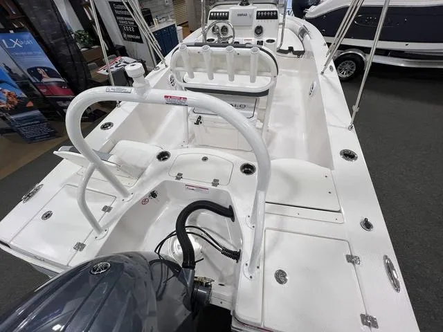 Slide: The Image of 2024 Robalo 206 Cayman boat interior with seating and controls, displayed indoors. - 8