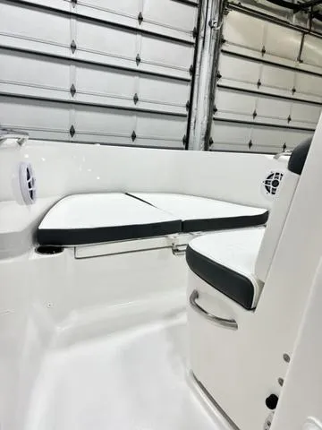 Slide: The Image of 2024 Robalo R180 boat interior with cushioned seating and modern design. - 12