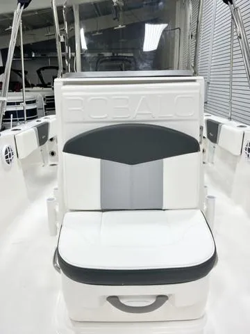 Slide: The Image of 2024 Robalo R180 boat interior with cushioned seating and sleek design. - 13