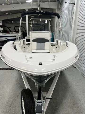 Slide: The Image of 2024 Robalo R180 boat in showroom, front view, sleek design. - 3
