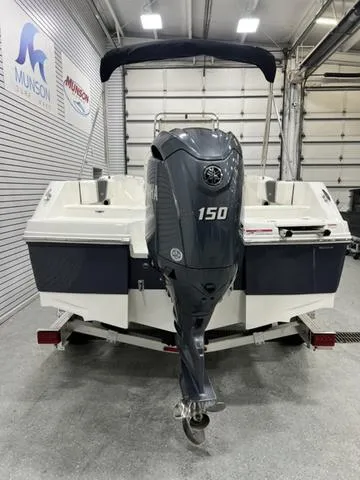 Slide: The Image of 2024 Robalo R180 boat with 150 HP engine in a showroom. - 4