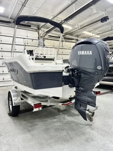 Slide: The Image of 2024 Robalo R180 boat with Yamaha engine in a garage setting. - 5