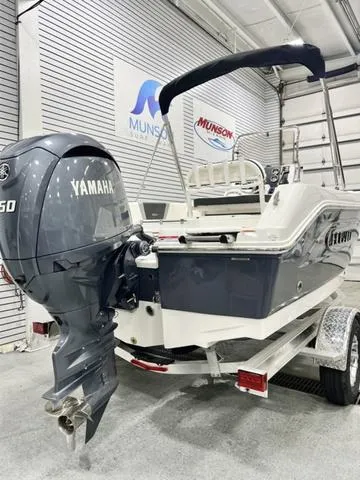 Slide: The Image of 2024 Robalo R180 boat with Yamaha engine in showroom setting. - 6