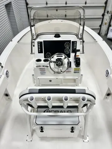 Slide: The Image of 2024 Robalo R180 boat interior with steering console and rod holders. - 7