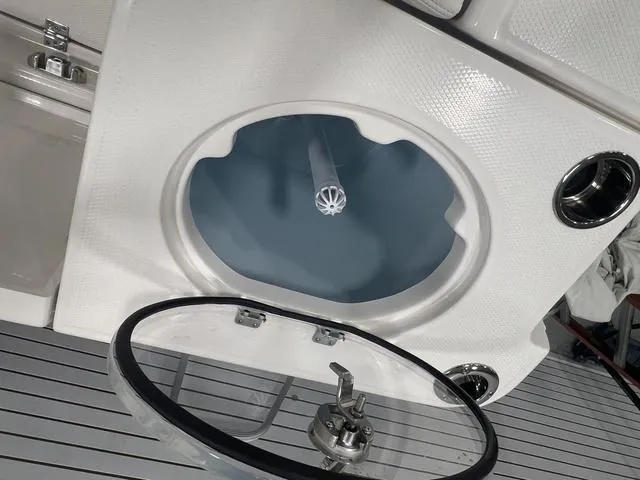 Slide: The Image of 2024 Robalo R250 boat livewell with open lid and sleek design. - 12