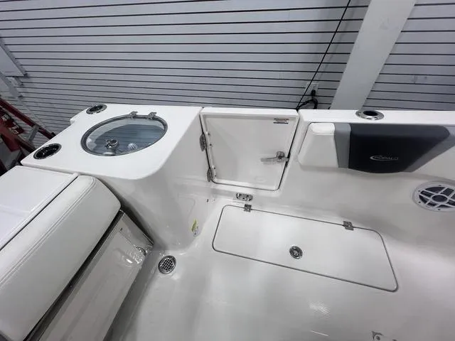 Slide: The Image of 2024 Robalo R250 boat interior with storage compartments and seating. - 13