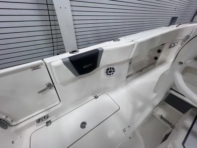 Slide: The Image of 2024 Robalo R250 boat interior with sleek white design and storage compartments. - 14