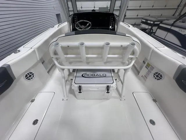 Slide: The Image of 2024 Robalo R250 boat interior with seating and steering console. - 15