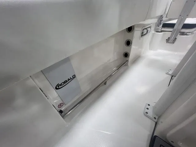 Slide: The Image of 2024 Robalo R250 boat interior, featuring sleek white design and modern fittings. - 16