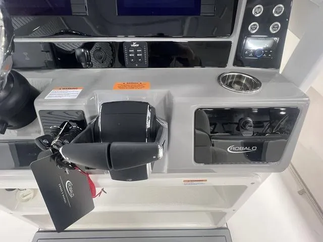 Slide: The Image of 2024 Robalo R250 boat dashboard with controls and branding. - 23