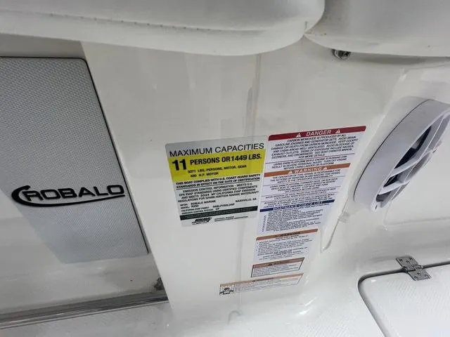 Slide: The Image of 2024 Robalo R250 boat capacity label, maximum 11 persons or 1449 lbs, safety warnings visible. - 24