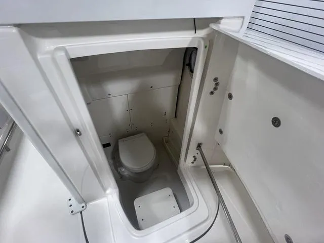 Slide: The Image of 2024 Robalo R250 boat interior with compact marine toilet. - 29