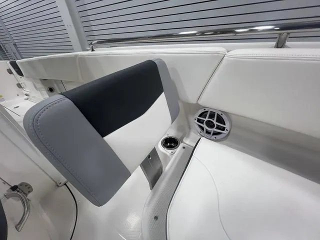 Slide: The Image of 2024 Robalo R250 boat interior with cushioned seating and speaker detail. - 39