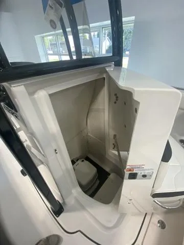 Slide: The Image of 2024 Robalo R222EX boat interior with open storage compartment. - 12