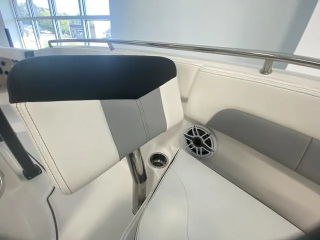Slide: The Image of 2024 Robalo R222EX boat interior with cushioned seating and speaker detail. - 16