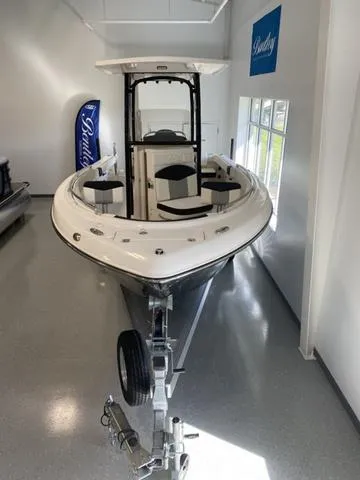 Slide: The Image of 2024 Robalo R222EX boat on trailer in showroom, front view. - 3