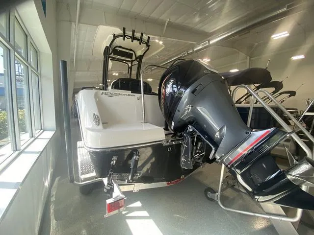 Slide: The Image of 2024 Robalo R222EX boat with powerful outboard motor in showroom. - 5