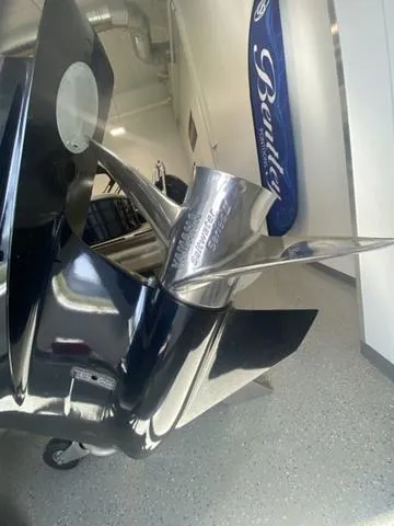 Slide: The Image of 2024 Robalo R222EX boat propeller in showroom with Bentley sign. - 6