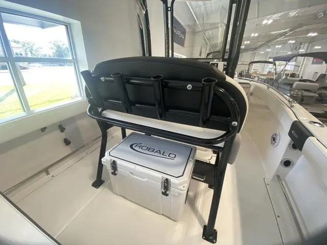 Slide: The Image of 2024 Robalo R222EX boat interior with seating and storage compartment. - 8