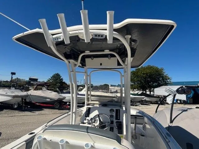 Slide: The Image of 2021 Robalo R222 boat with T-top and console, parked outdoors under clear blue sky. - 10