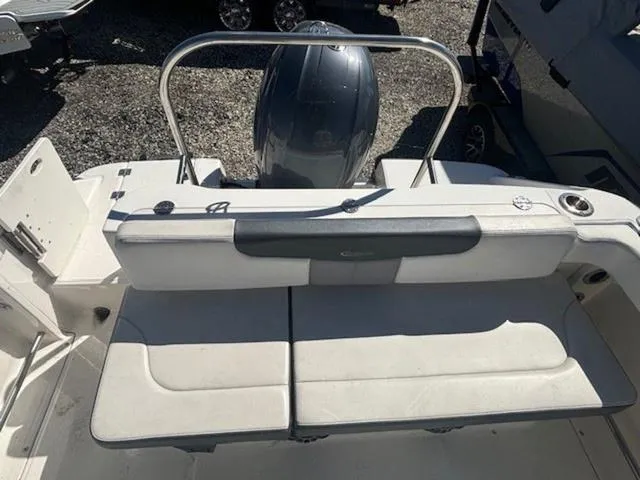 Slide: The Image of 2021 Robalo R222 boat interior with cushioned seating and motor view. - 11